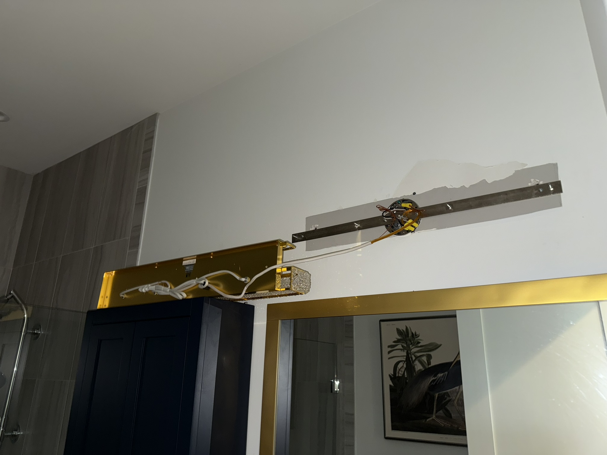 Vanity light fixture installation in progress